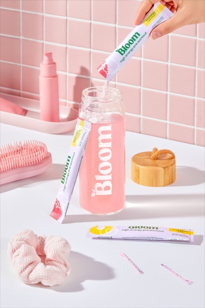 This creative showcases the preparation of pre-workout powder using a minimalist, monochromatic pink aesthetic to create a clean and aspirational brand experience.